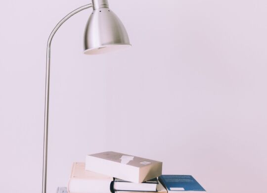 silver-desk-lamp-near-pile-of-books-1122530