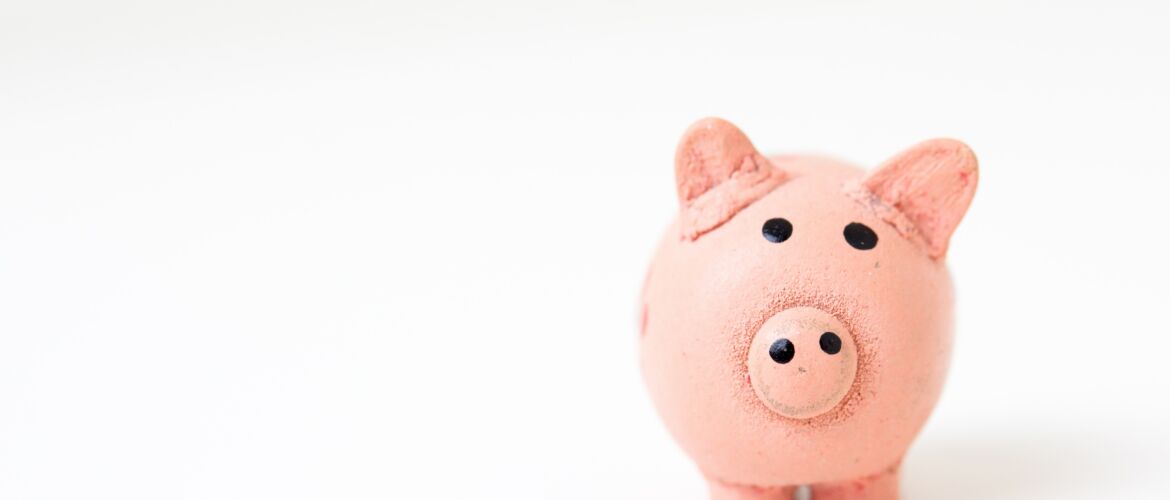 A pink piggy bank sitting on top of a table.