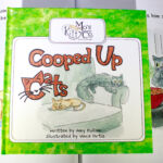 CoopCatsS4 A book about cats with the title of " cooped up cats ".